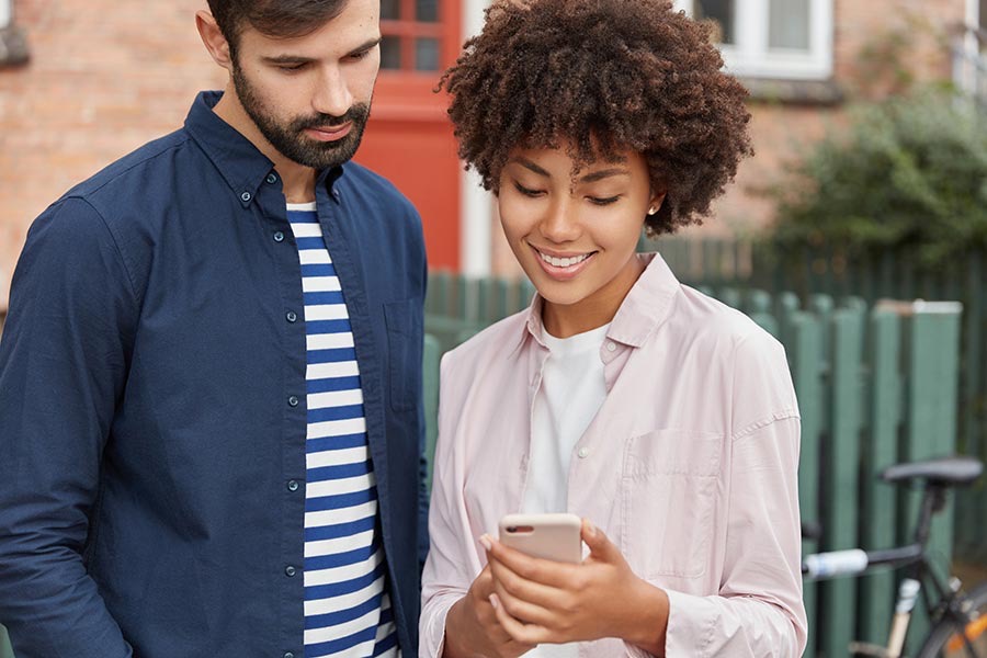 Couple checking wait time on a phone.